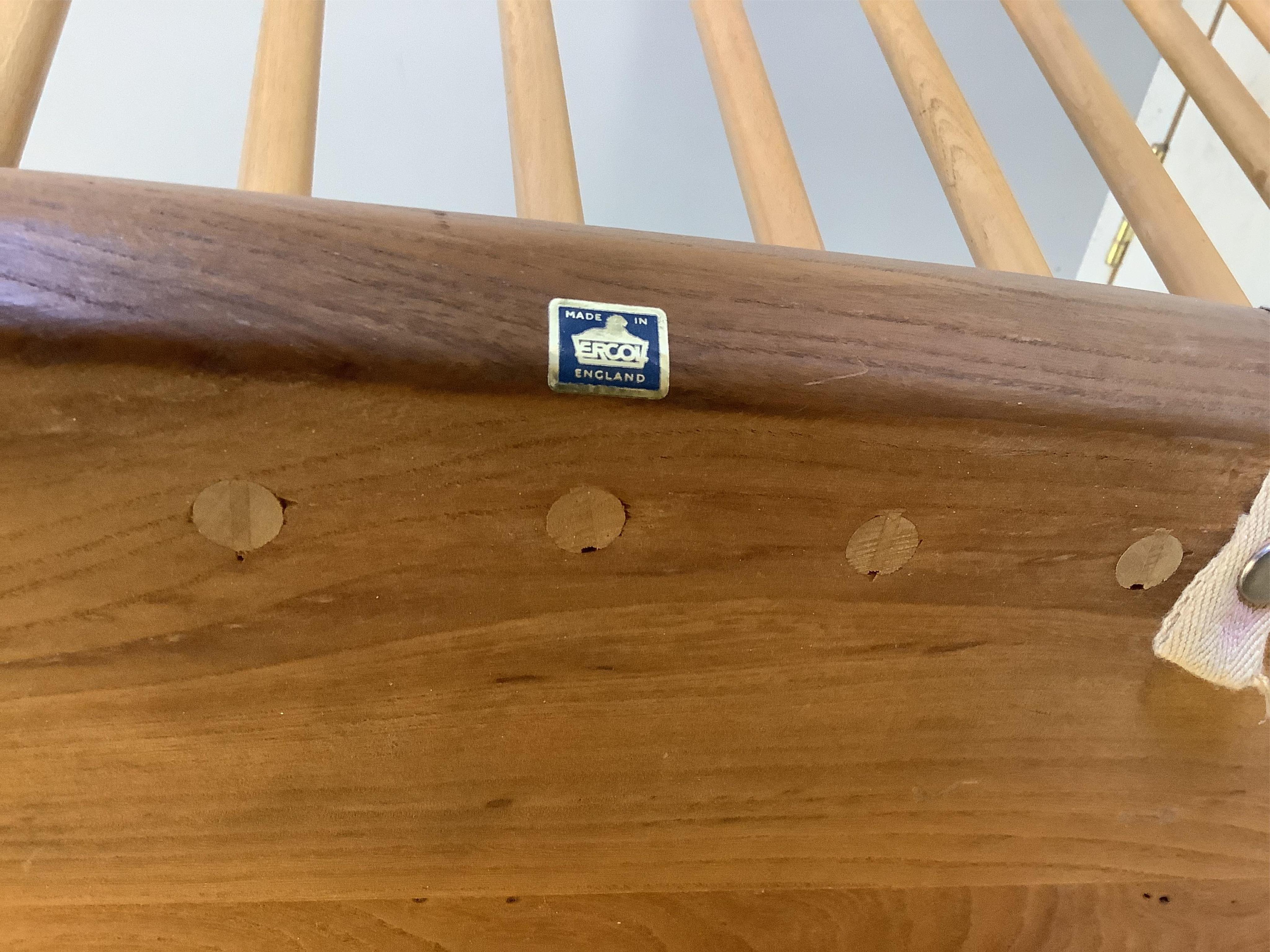 An Ercol elm and beech comb back bench with squab cushion seat, width 112cm, depth 44cm, height 78cm. Condition - fair